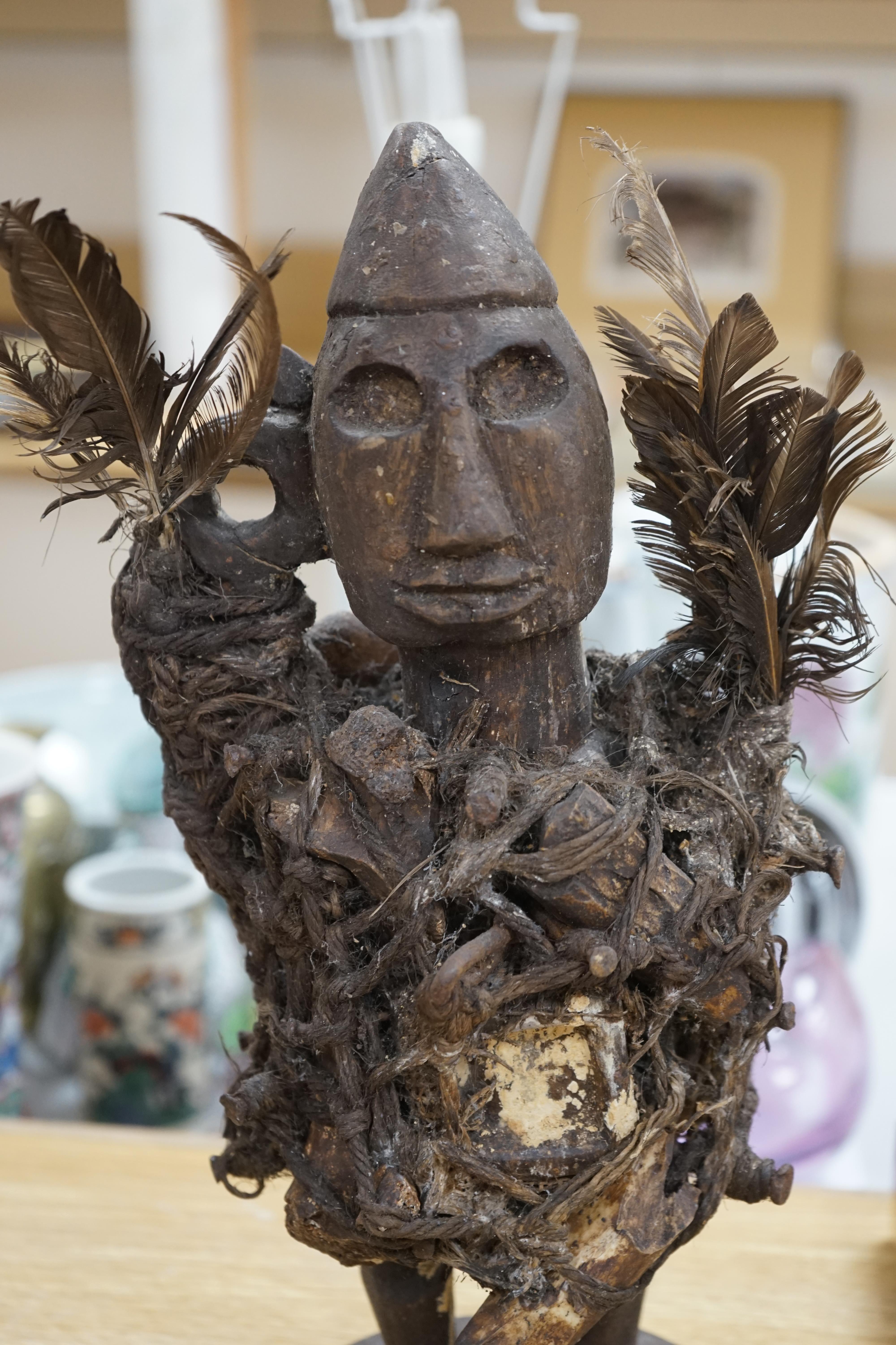 A Congo wood, feather and bone fetish figure, 39cm high. Condition - fair